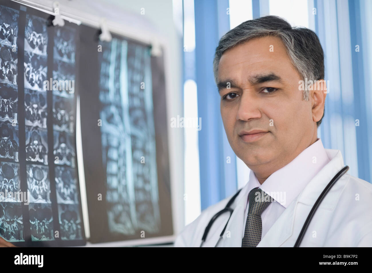Doctor examining an x-ray report Stock Photo