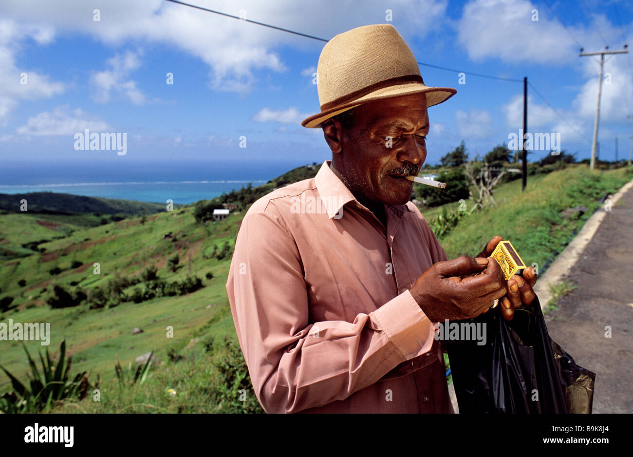 Mauritius, Rodrigues Island, on the road to Quatre Vents, Clarence Doliska has a break for a cigarette Stock Photo
