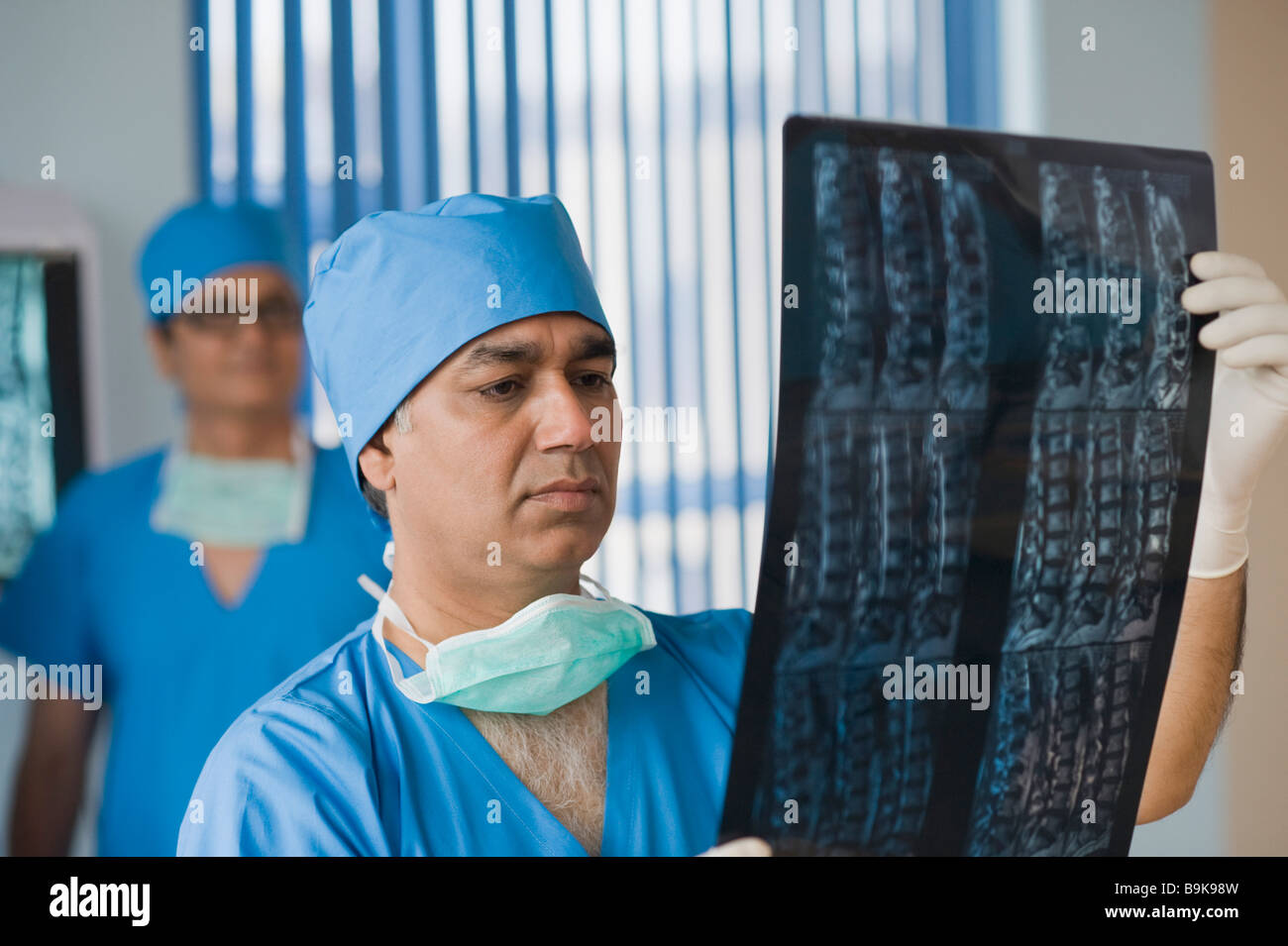 Surgeon examining an x-ray report Stock Photo