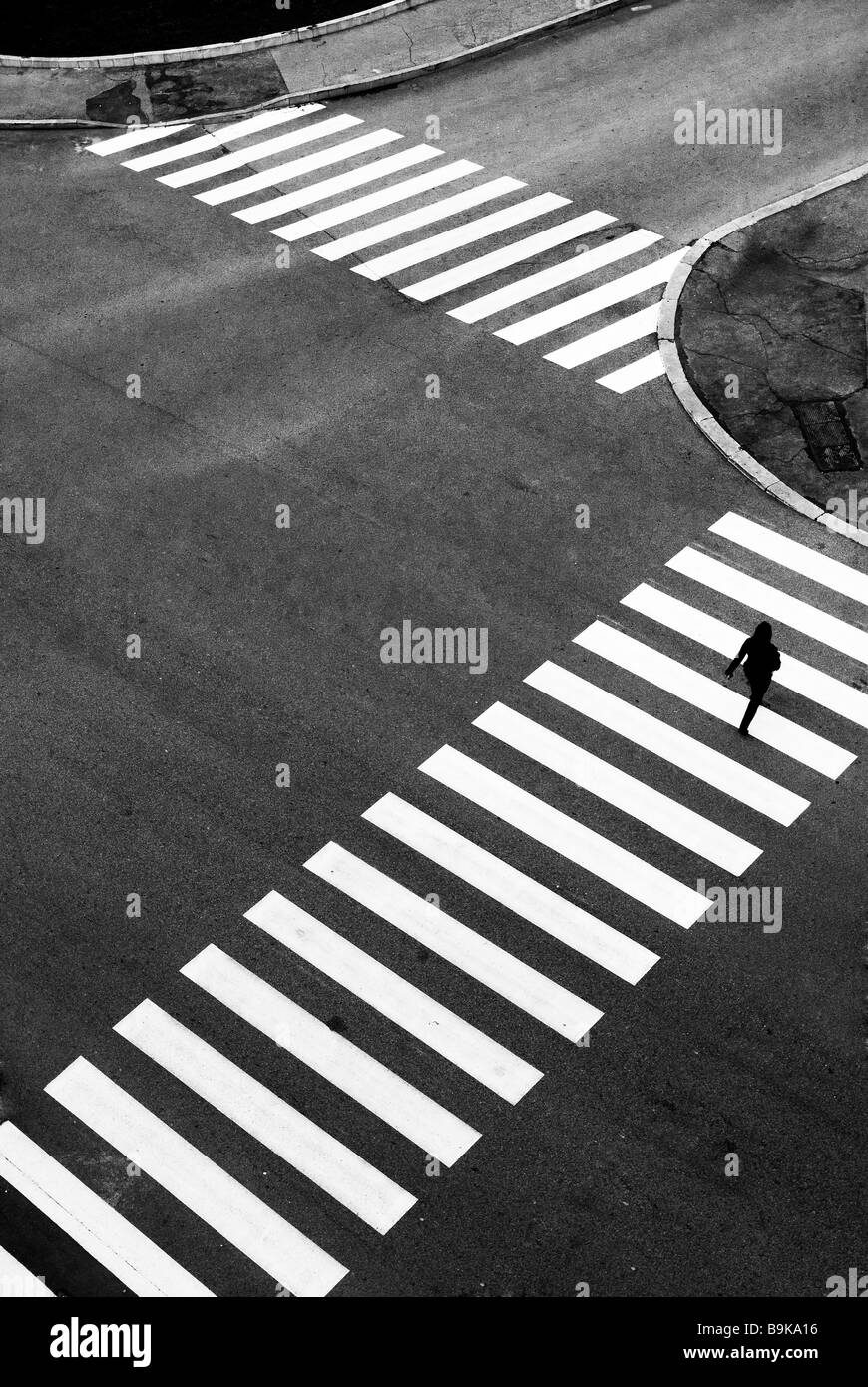 Woman crossing the zebra crossing Stock Photo