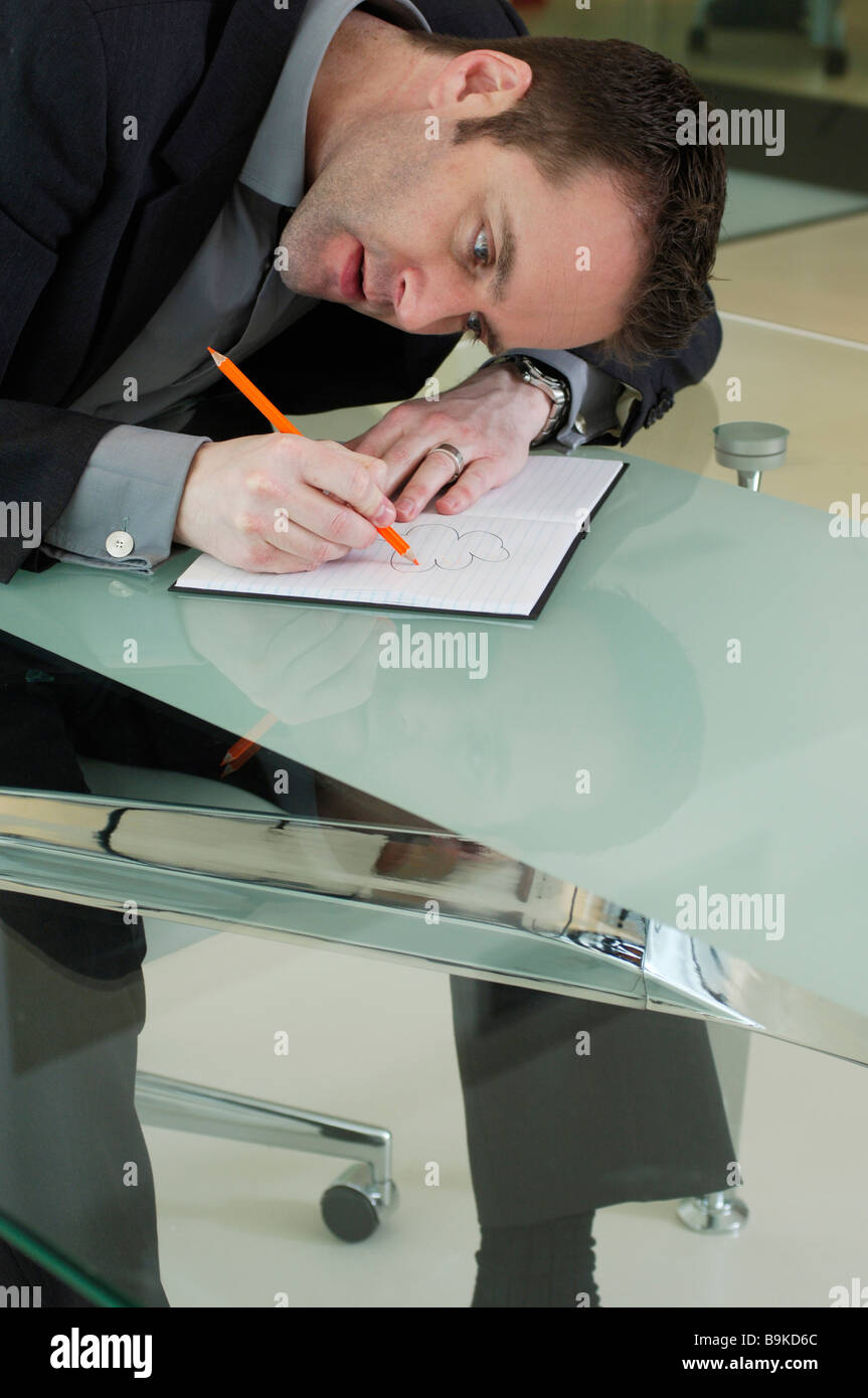 executive doodling in his book during a meeting Stock Photo Alamy