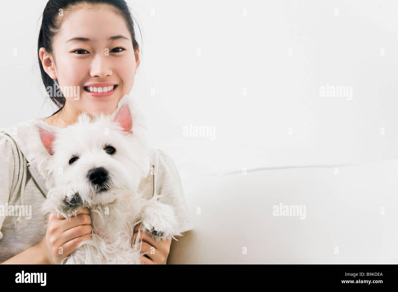 portrait of japanese girl with west highland terrier Stock Photo