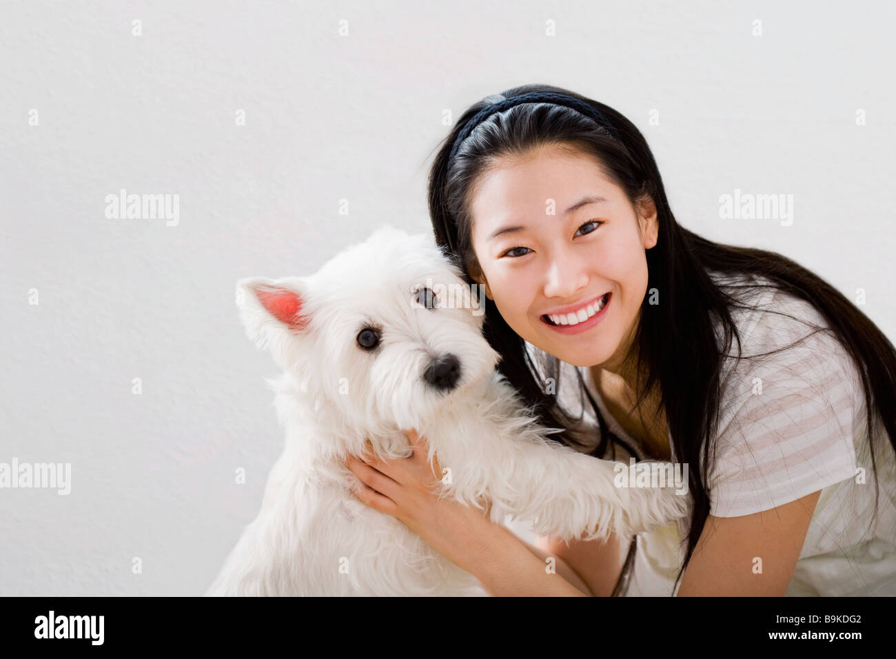 portrait of young japanese girl with west highland terrier Stock Photo
