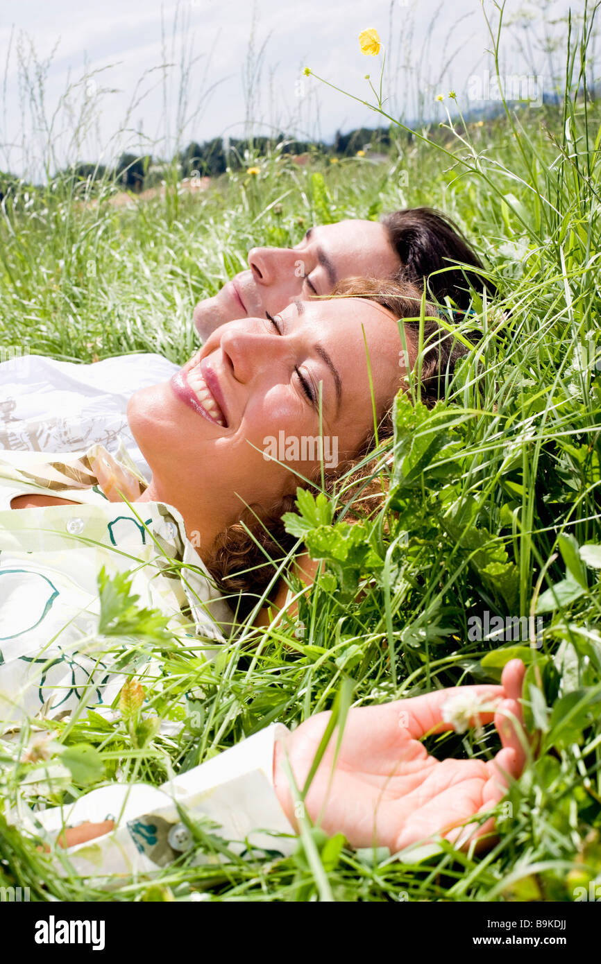portrait of young couple relaxing in grass Stock Photo - Alamy