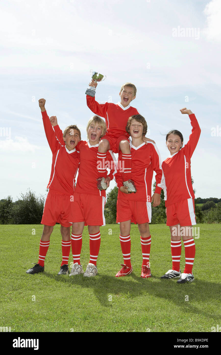 Football team holding trophy Stock Photo