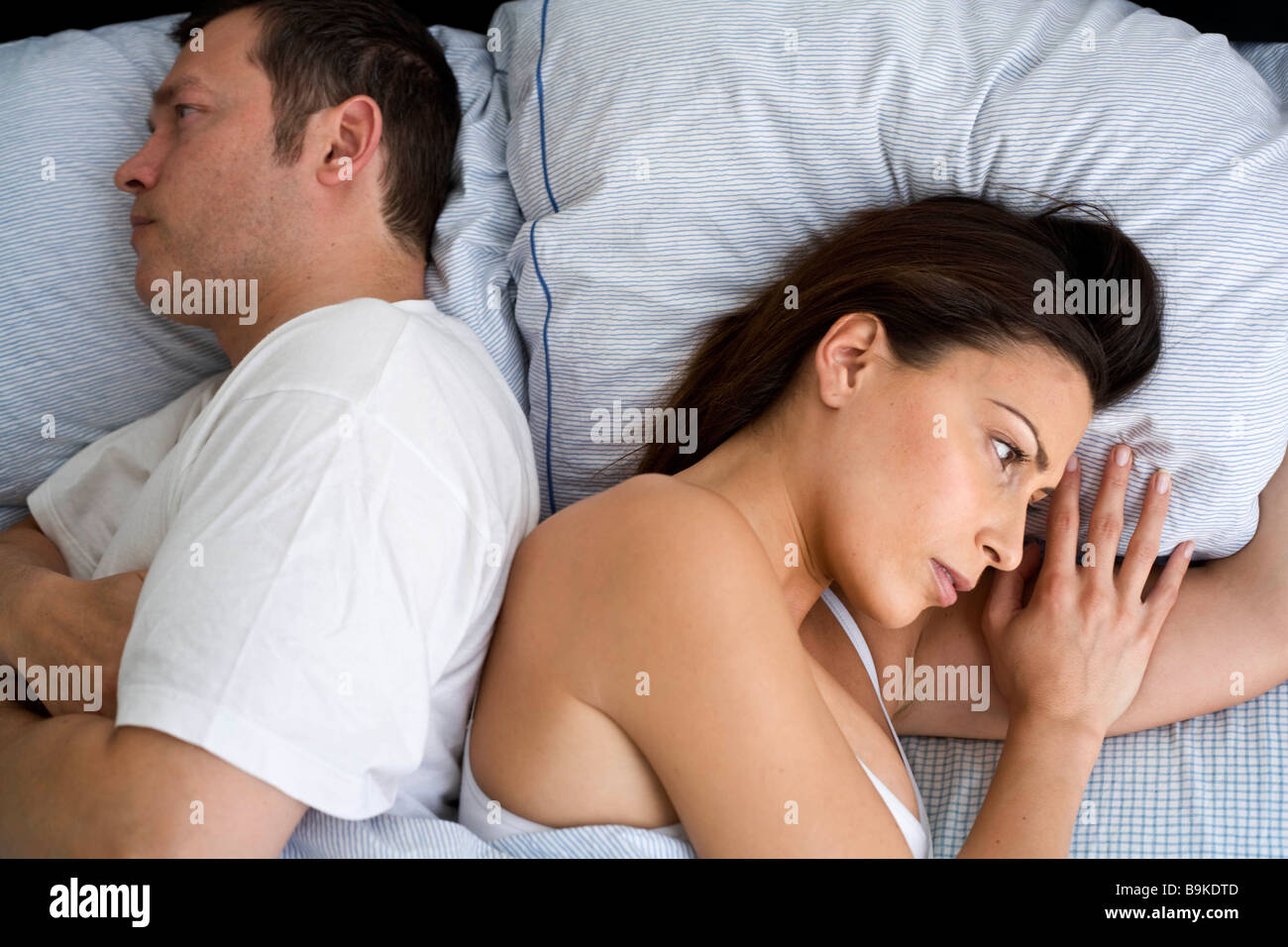 Young couple at home in bed Stock Photo