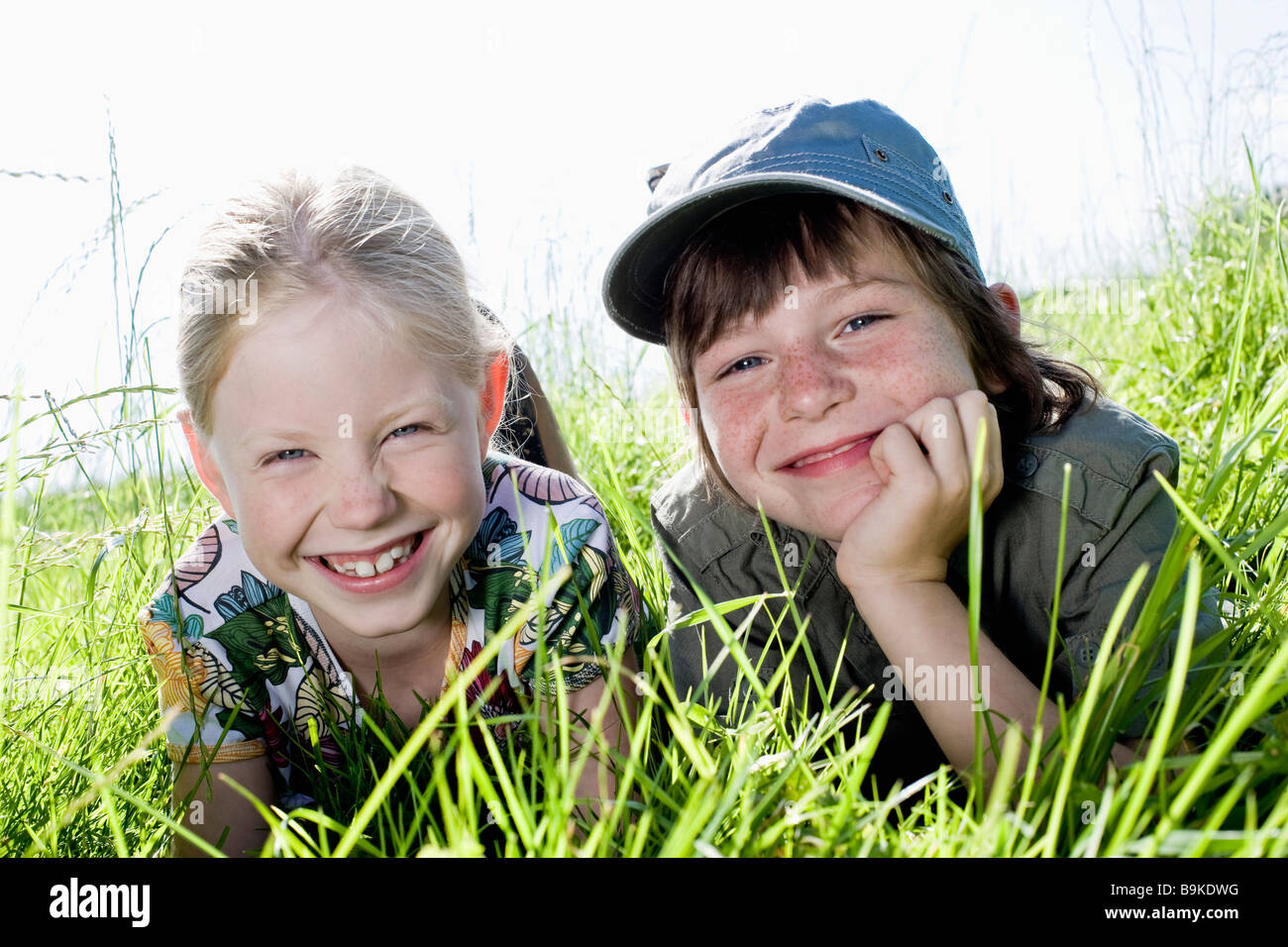 portrait of sister and brother relaxing in grass Stock Photo - Alamy