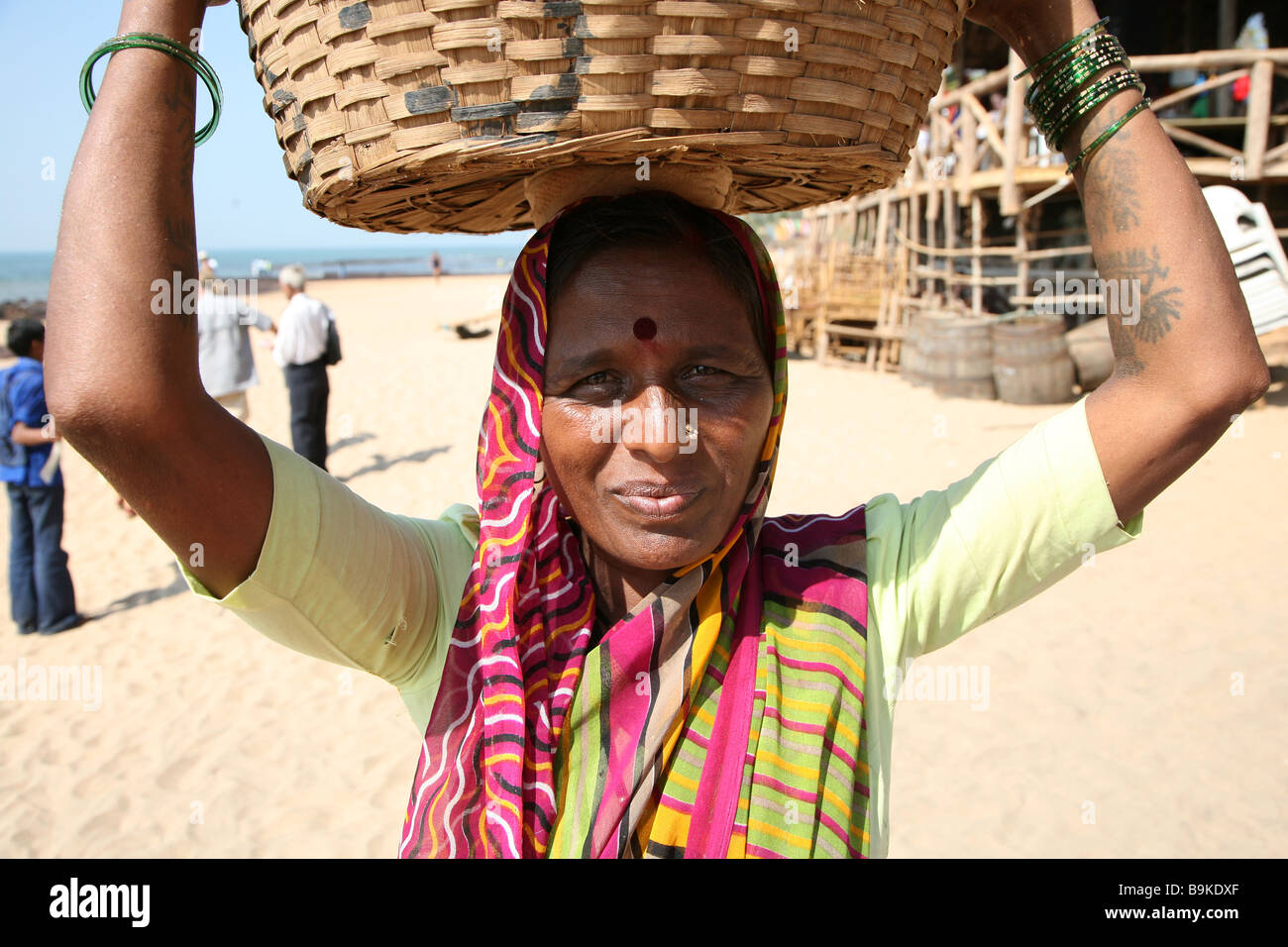 A beach vendor selling fruit carries the basket on her head in Anjuna,  northern Goa in India Stock Photo - Alamy