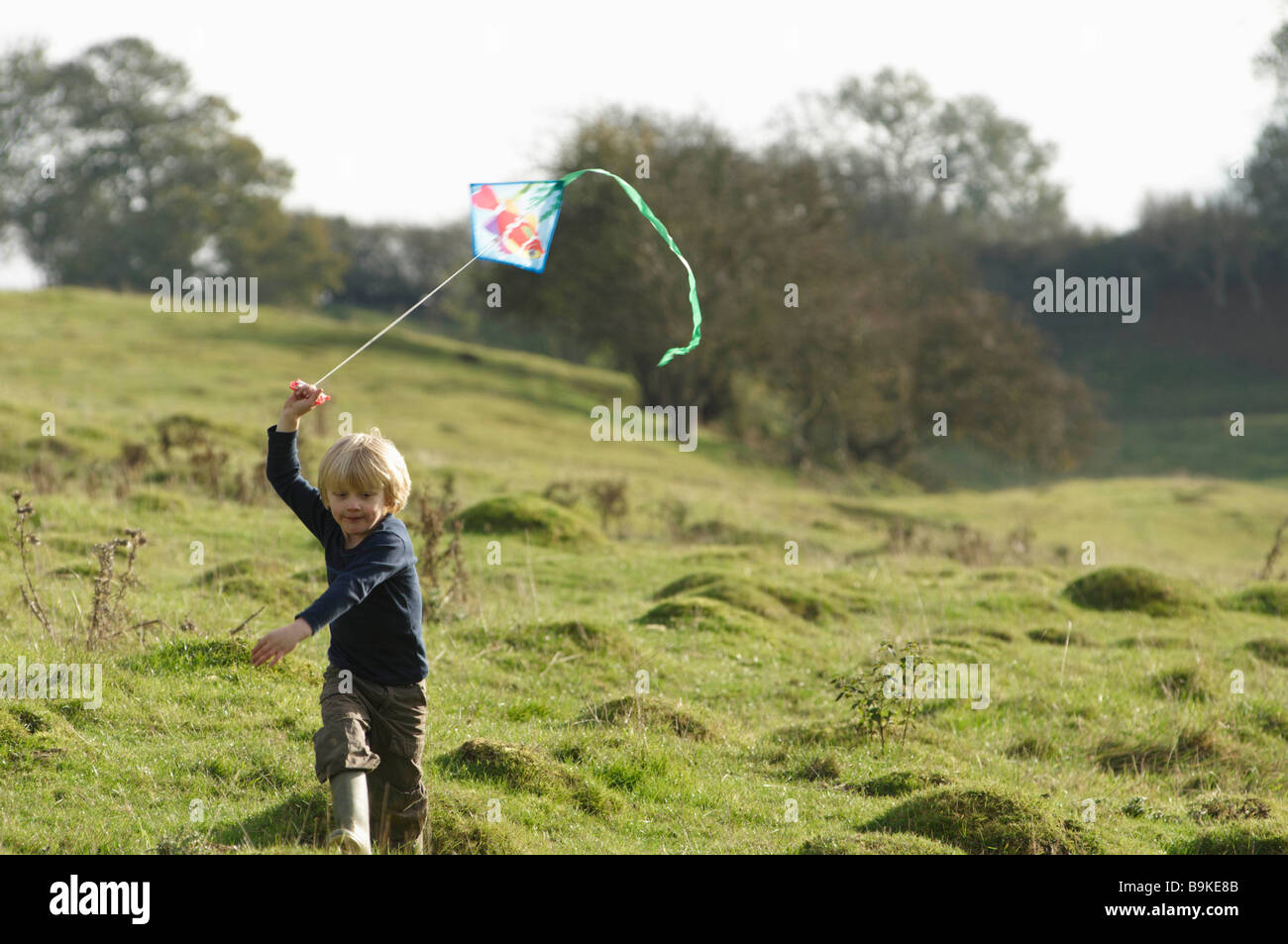 Young boy running with kite Stock Photo Alamy