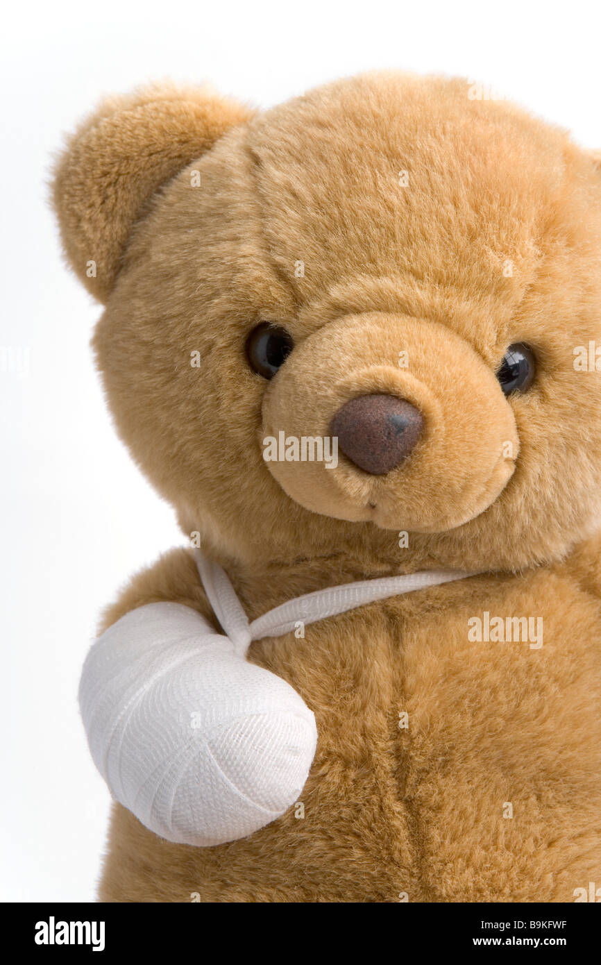 Toy bear with a broken leg Stock Photo