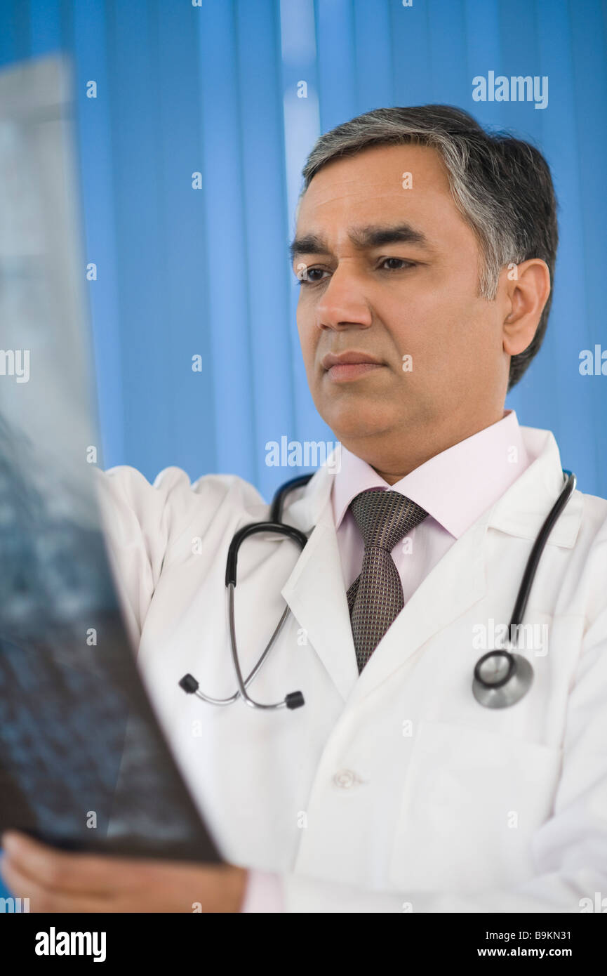 Doctor examining an x-ray report Stock Photo