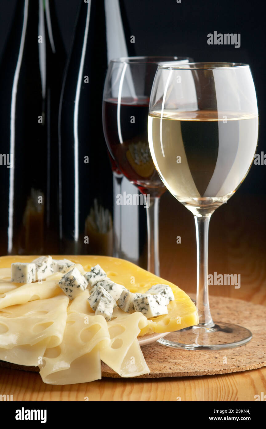 still life with cheeses red and white wines on the black background Stock Photo