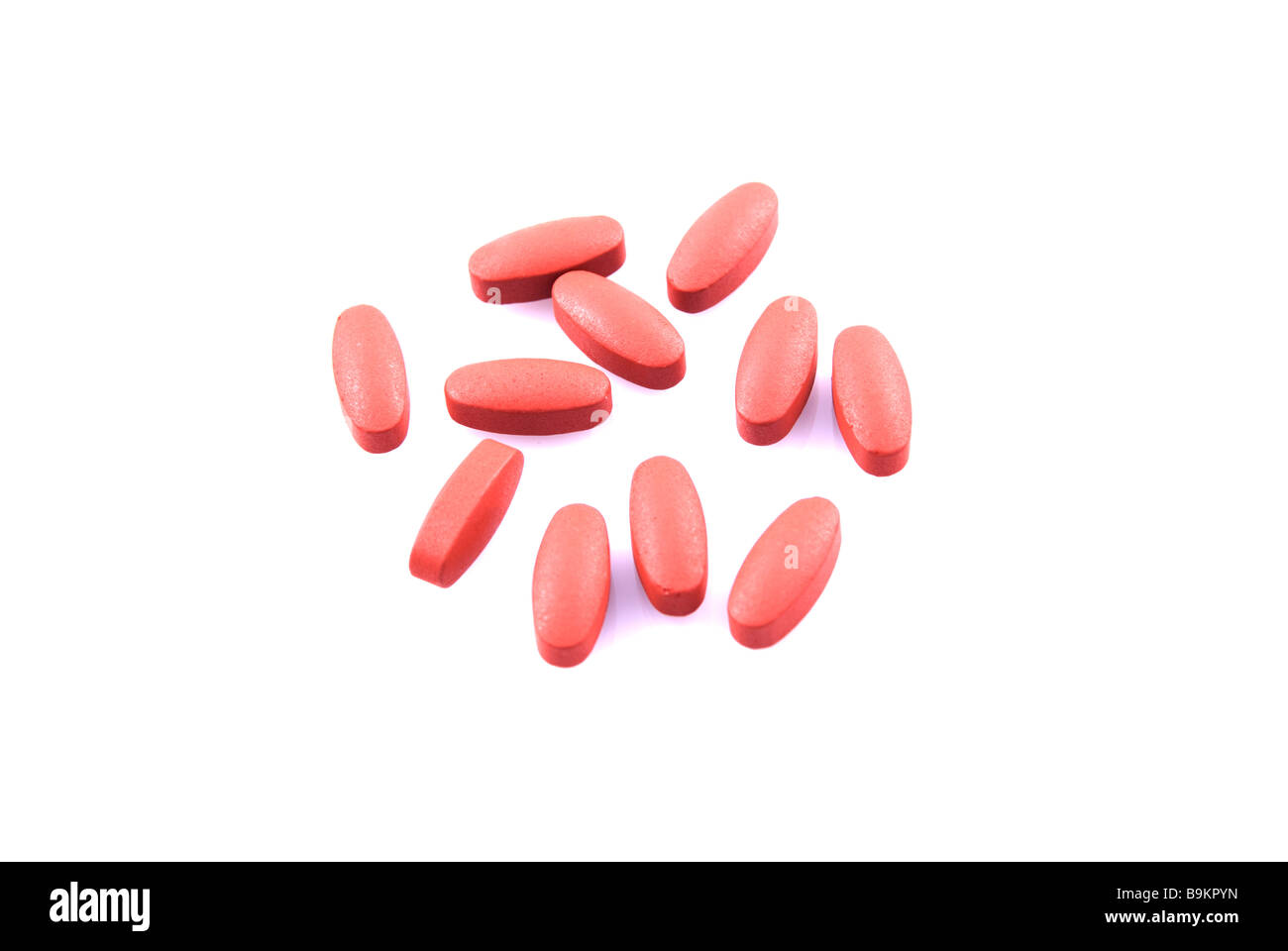 Red pills isolated against a white background Stock Photo