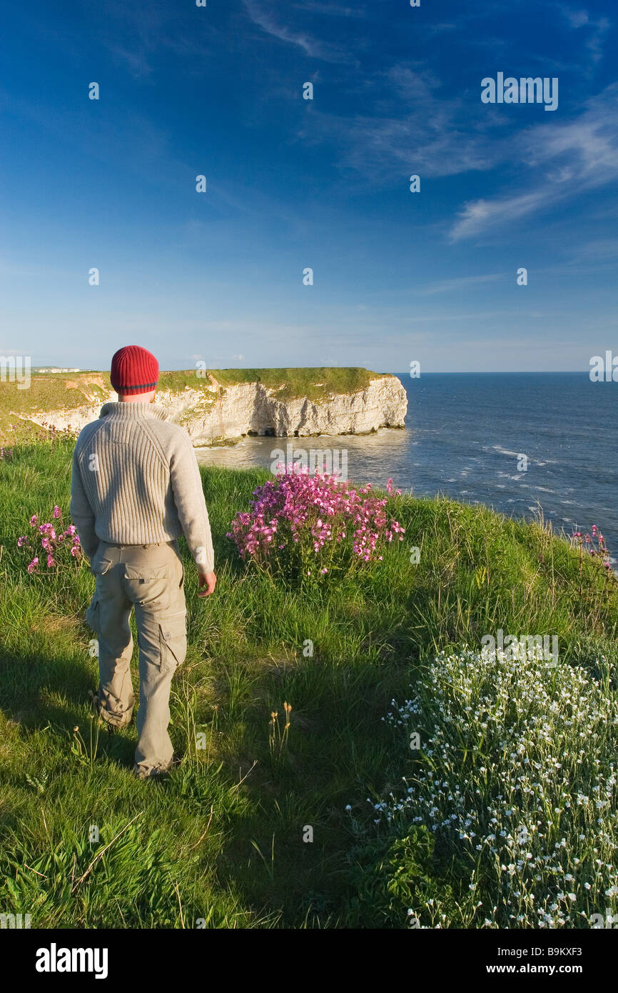 A visitor enjoying the view from the cliff tops on the Flamborough Headland Heritage Coast East Riding of Yorkshire Stock Photo