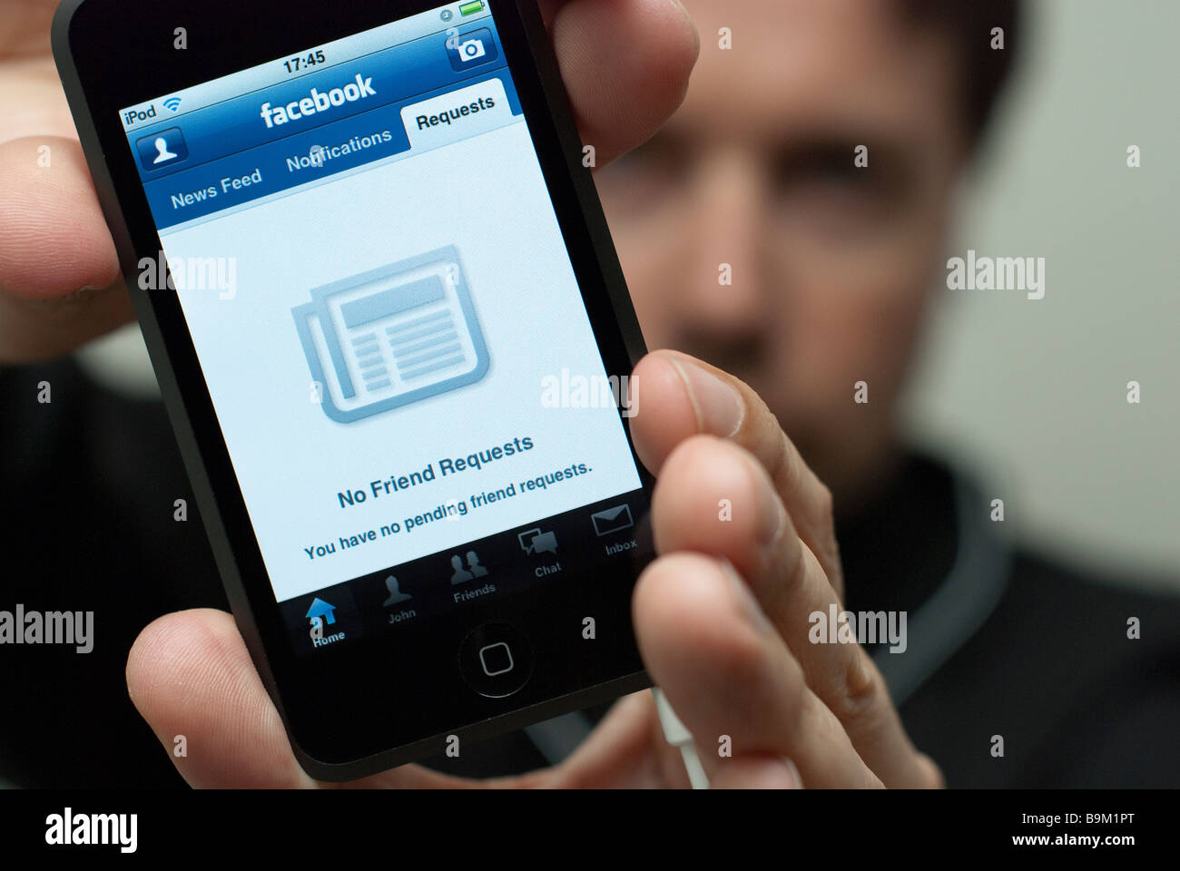 Man Holding An Apple Ipod Touch That Displays The No Friend Requests Stock Photo Alamy