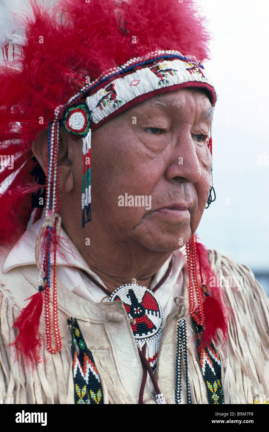 Elderly Native American Indian Chief wearing Traditional Ceremonial War Bonnet / Headdress and Regalia - Portrait Stock Photo