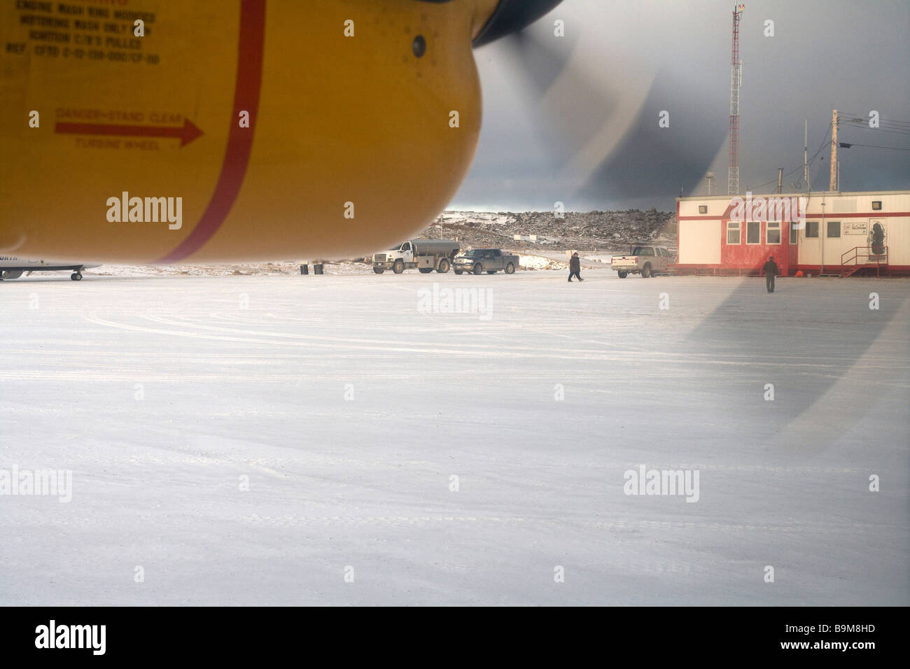 Snow covered airport runway with airplane propeller in motion, detail, Canadian Arctic, Canada Stock Photo