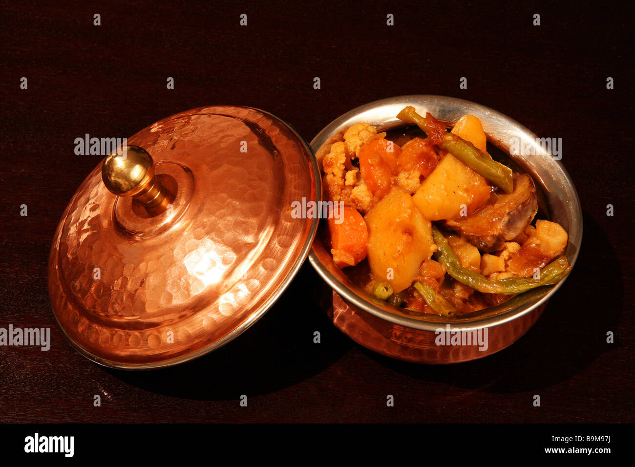 A traditional Indian vegetable curry in an authentic copperclad