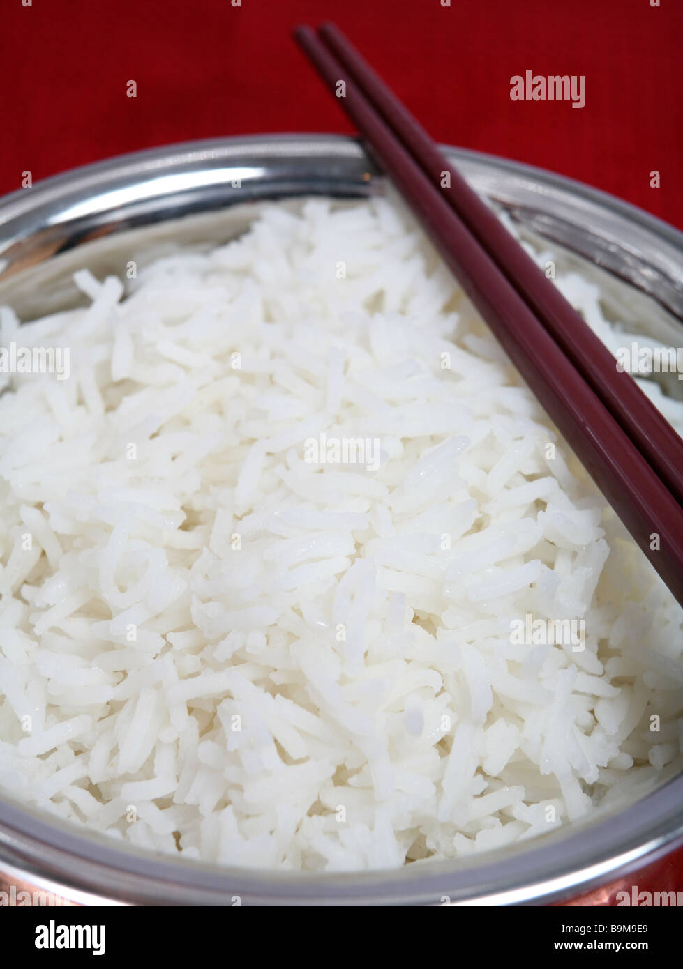 Boiled Basmati rice in a metal bowl with chopsticks Stock Photo Alamy