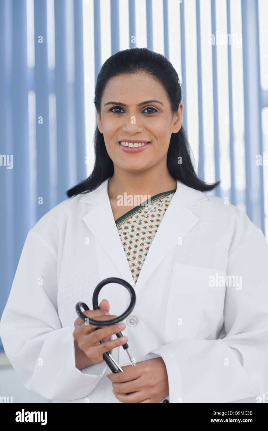 Female doctor holding a stethoscope Stock Photo