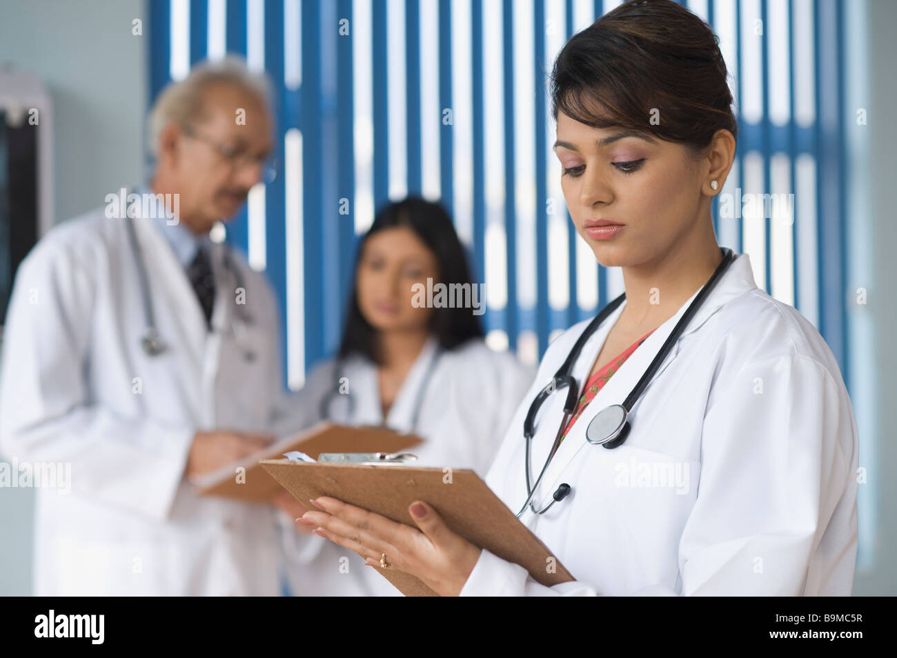 Doctors examining a report Stock Photo