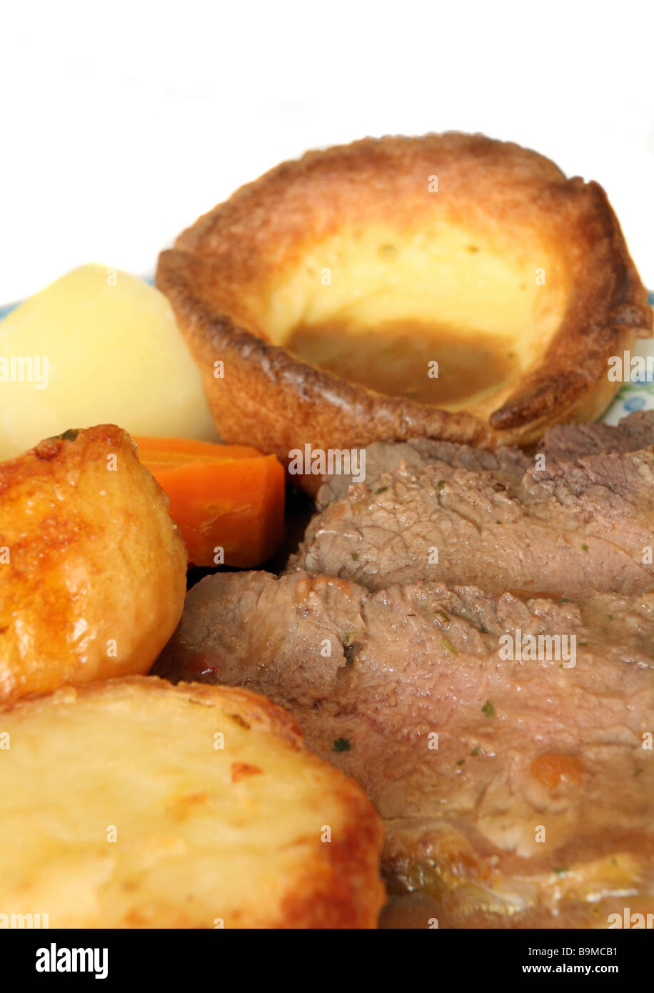 Roast beef and Yorkshire pudding,roast and boiled potatoes,boiled carrots and gravy. A