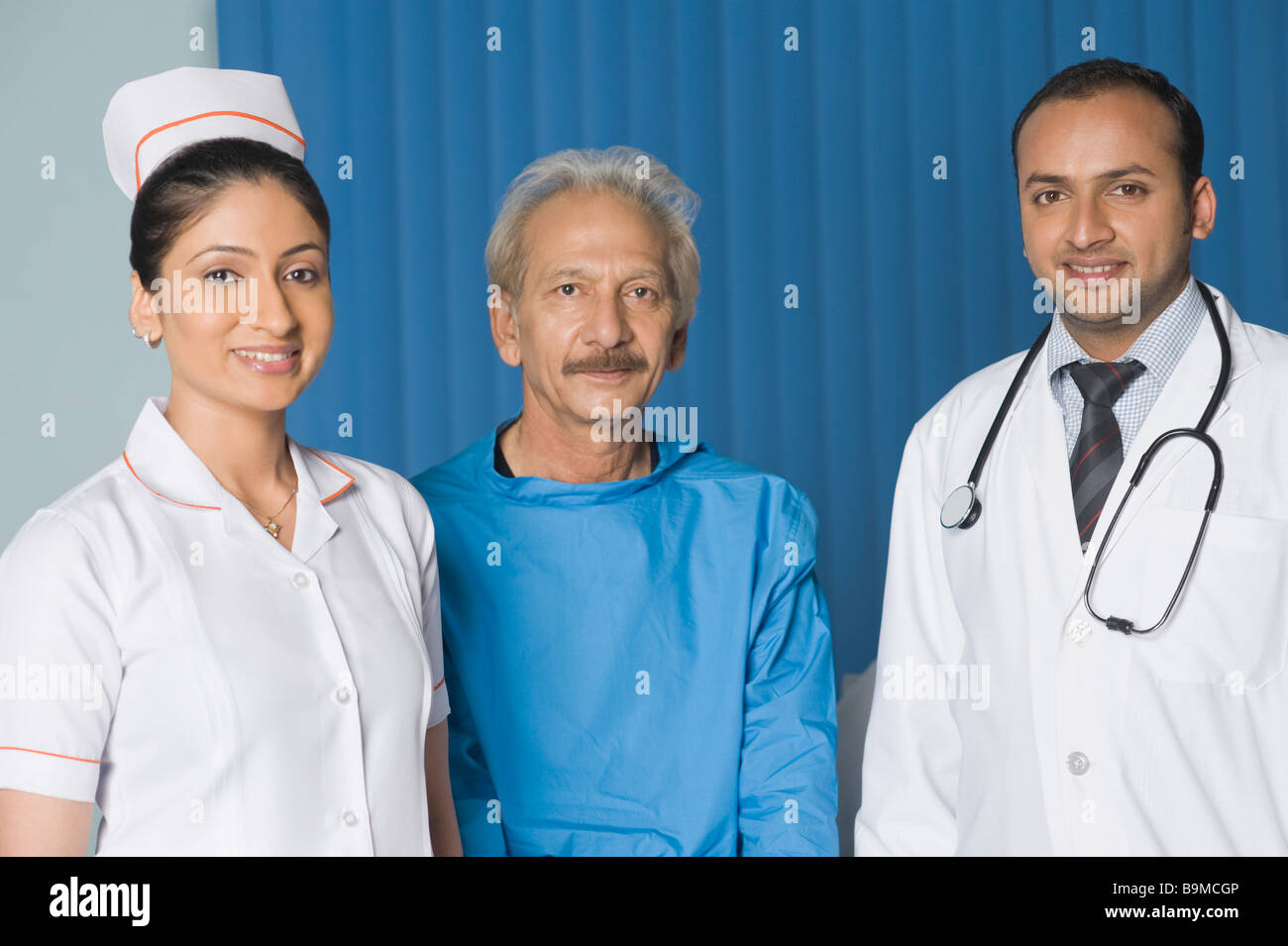 Portrait of doctors smiling with a patient Stock Photo