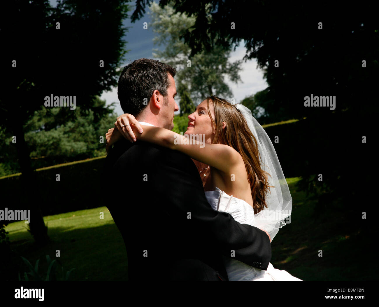 Bride and groom embracing in nature Stock Photo - Alamy
