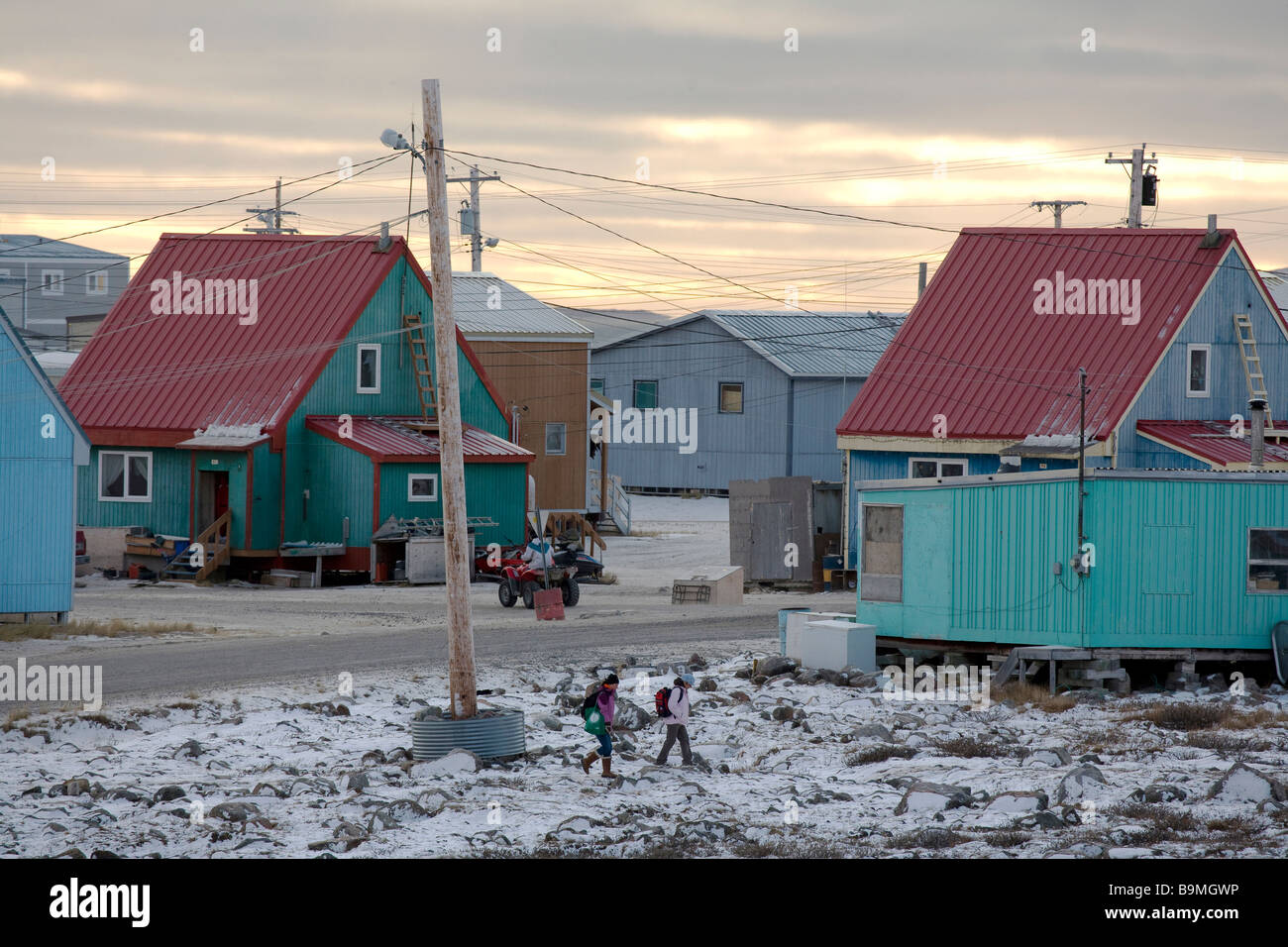 Schoolchildren walking by houses in Taloyoak inuit settlement Nunavut, Canadian arctic, Canada Stock Photo