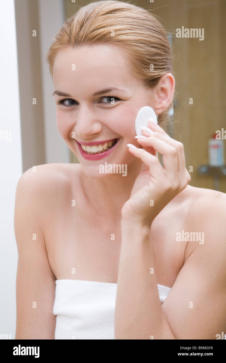 Young pretty woman cleaning face using cotton pad Stock Photo Alamy
