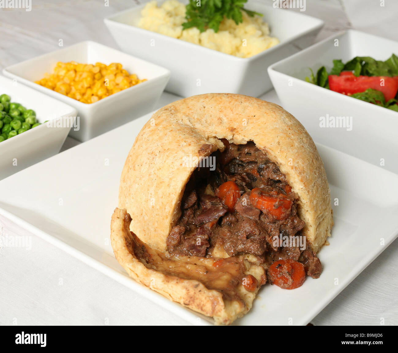 A steak and kidney pudding,with a steamed suet crust,on a buffet with
