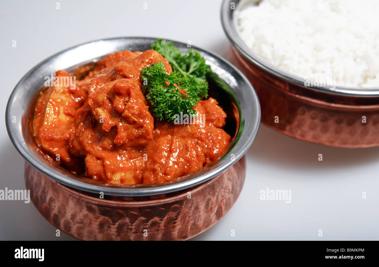 Serving bowls with a red Thai chicken curry,cooked with coconut milk