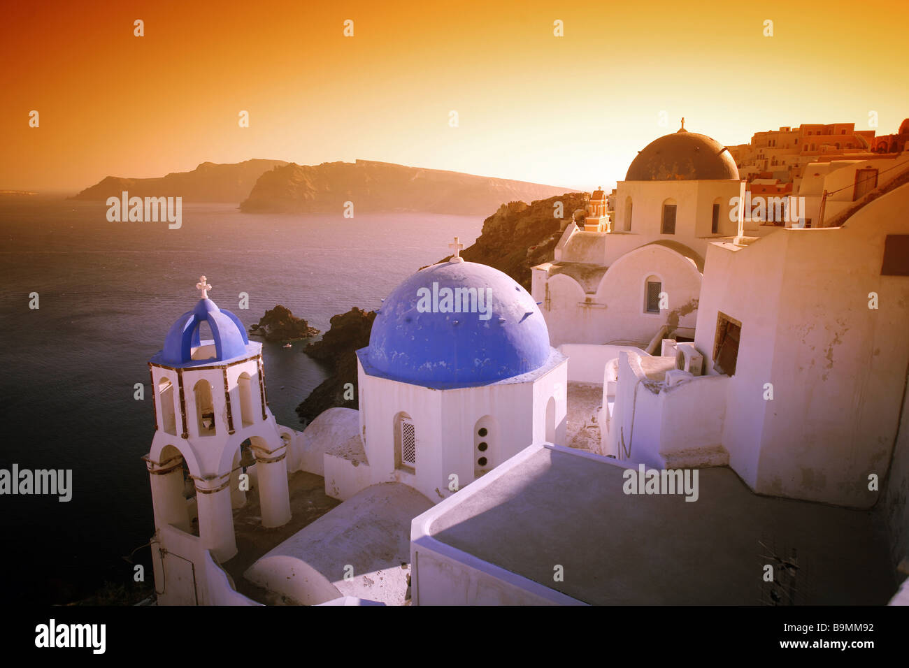 A surreal sunset effect over some of Santorini's world-famous churches. Stock Photo