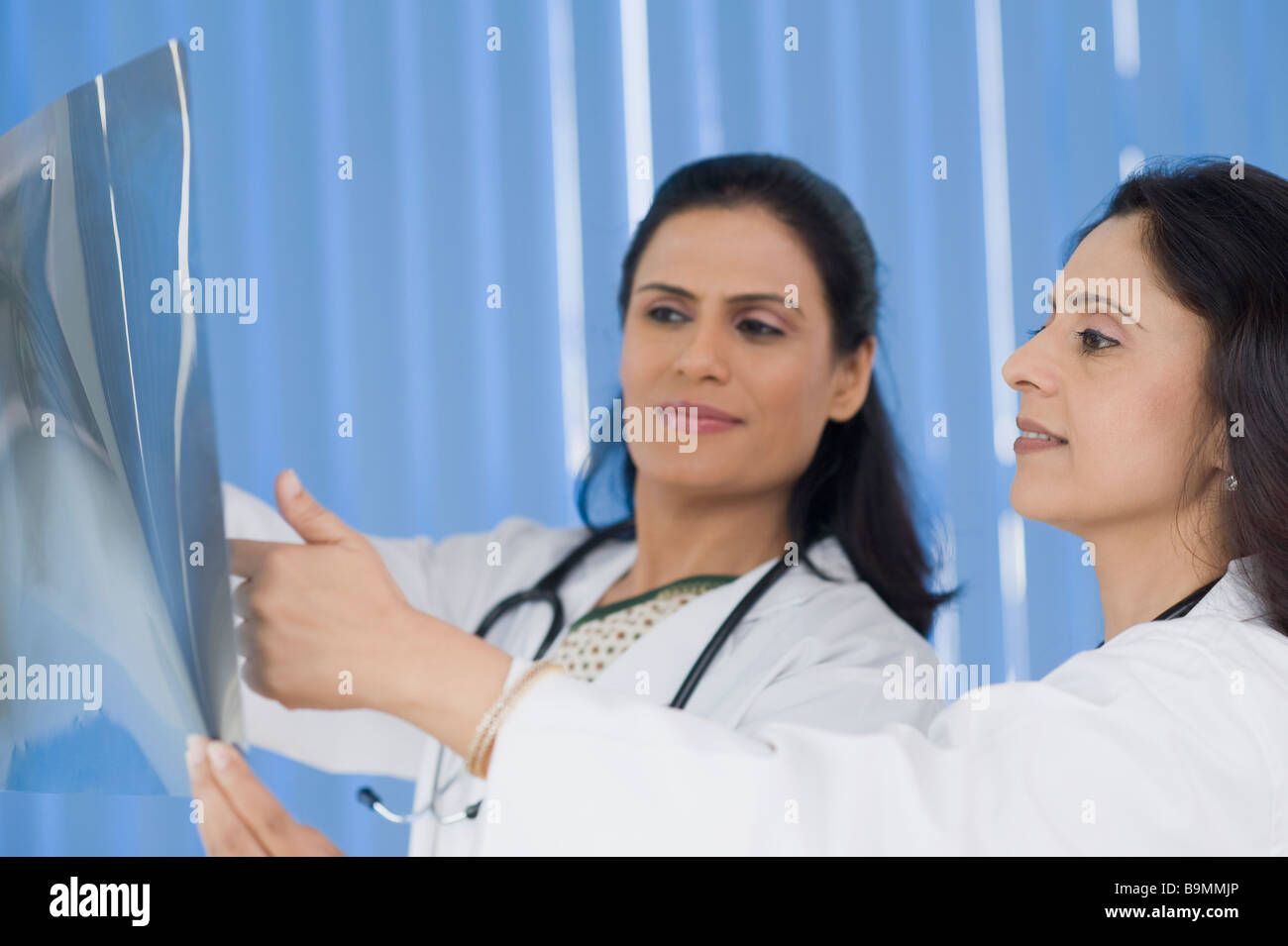 Female doctors examining an x-ray report Stock Photo