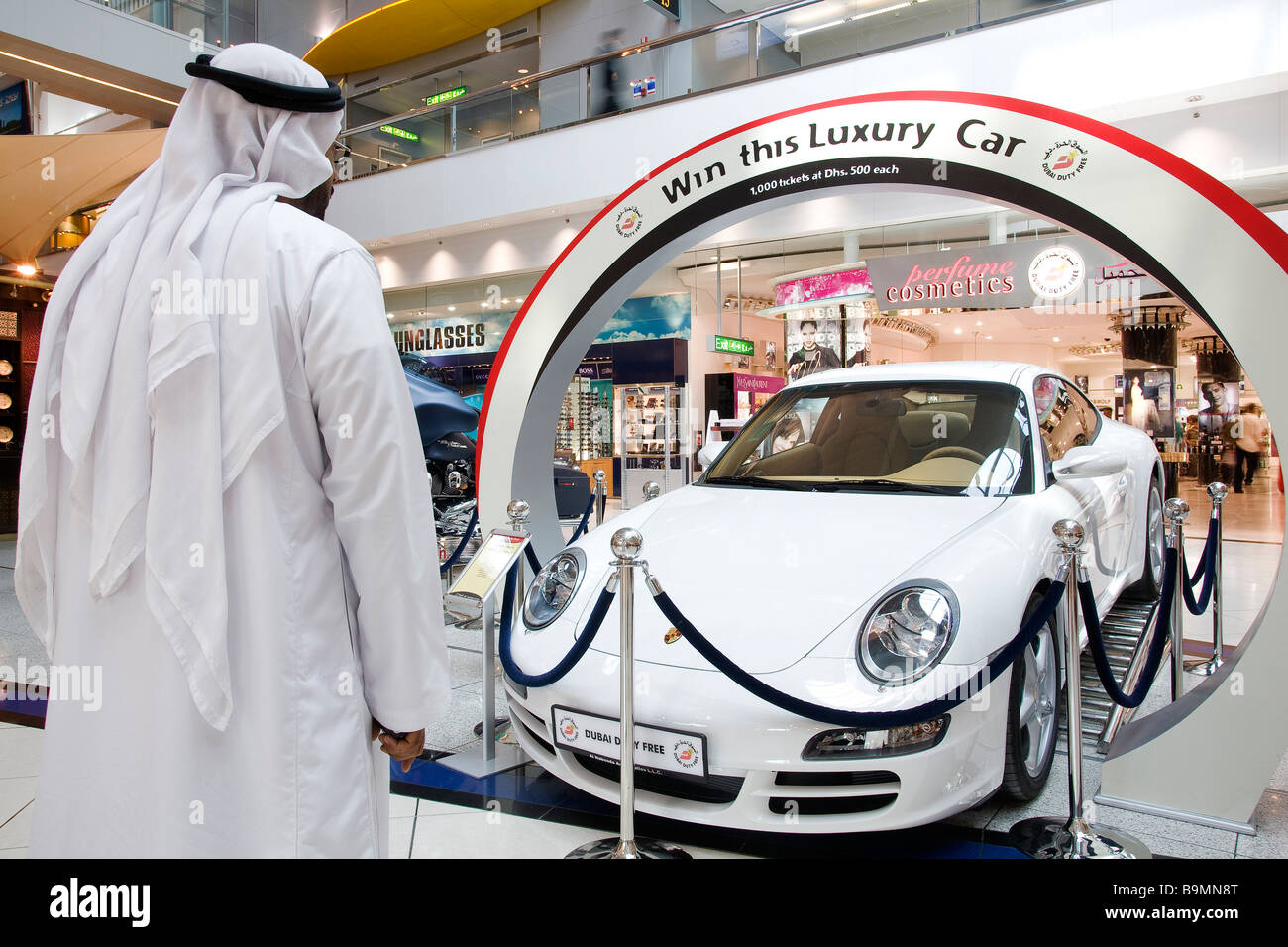 United Arab Emirates, Dubai, Dubai International Airport, Dubai Duty Free, Porsche 911 Carrera, tombola prize and man wearing a Stock Photo