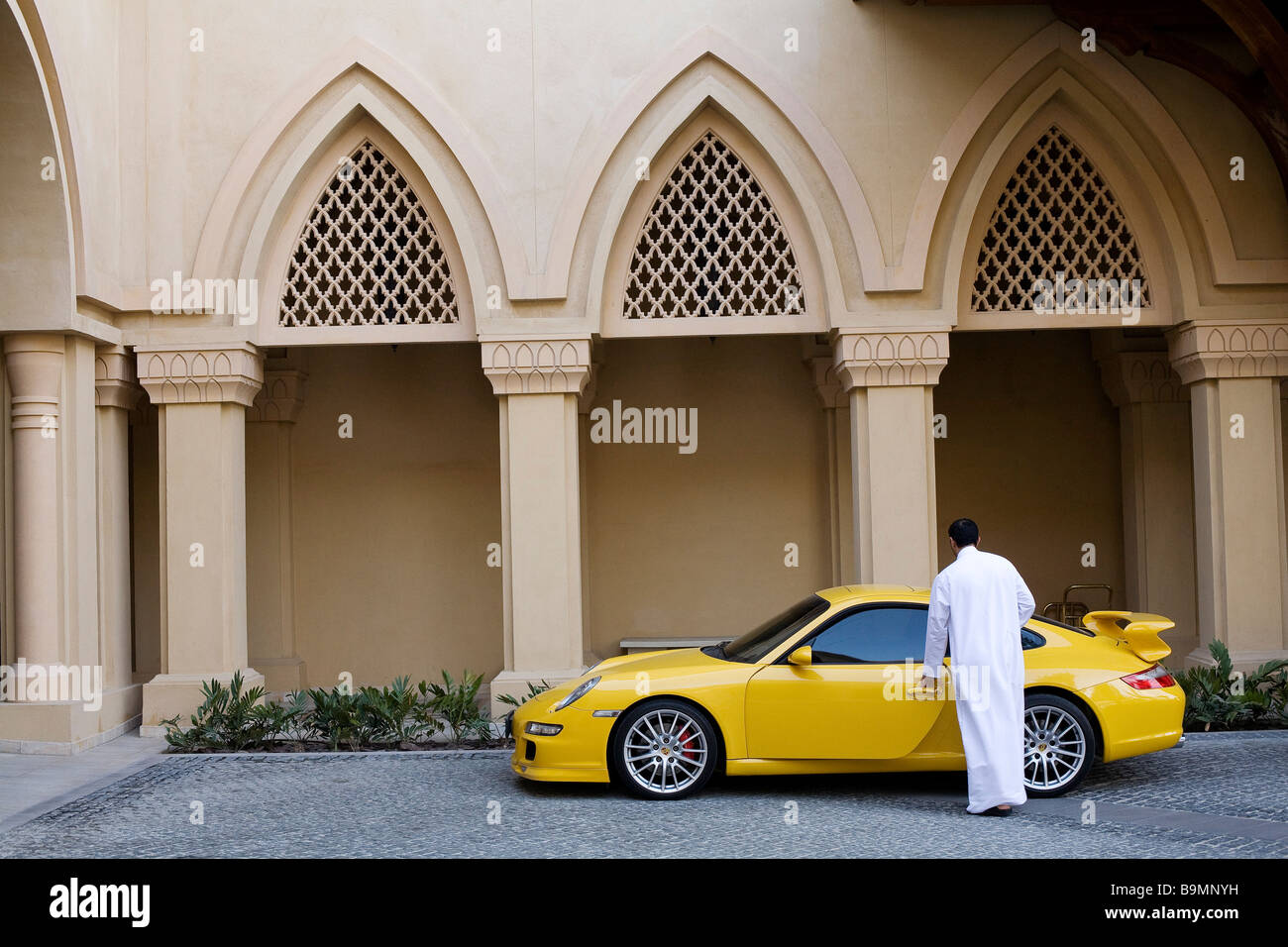 United Arab Emirates, Dubai, Downtown Burj Dubai, Sofitel The Palace The Old Town, principal entrance with a Porsche 911 Stock Photo