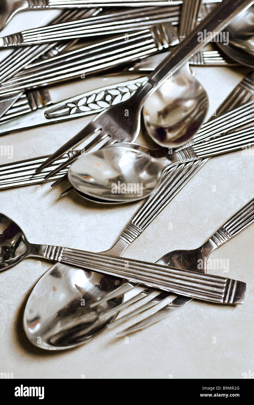Silverware spread out on table Stock Photo