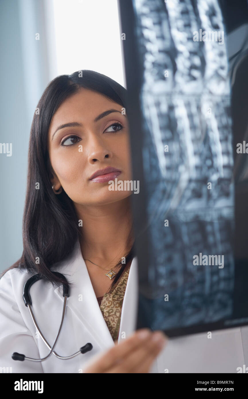 Female doctor examining an x-ray report Stock Photo