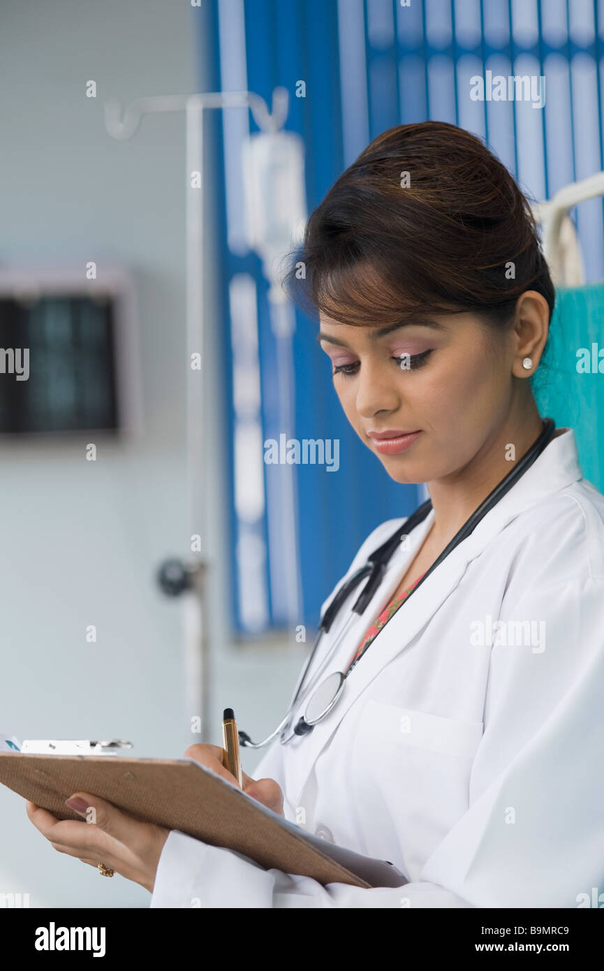 Female doctor writing a prescription Stock Photo - Alamy