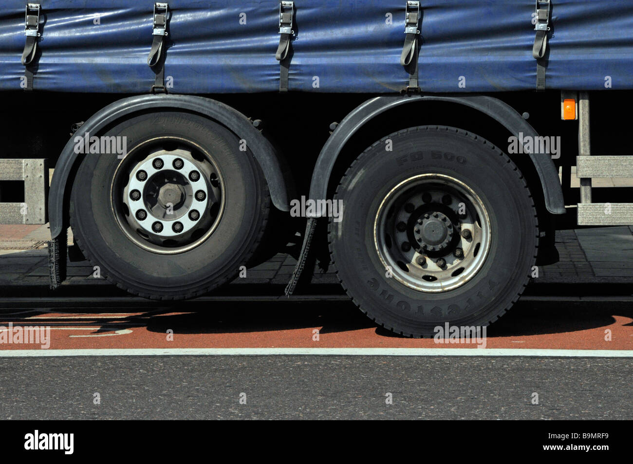 Raised lazy or dead drop droppable axle on rigid bodied lorry used to distribute heavy loads & raised to save tyre wear on soft sided curtain truck uk Stock Photo