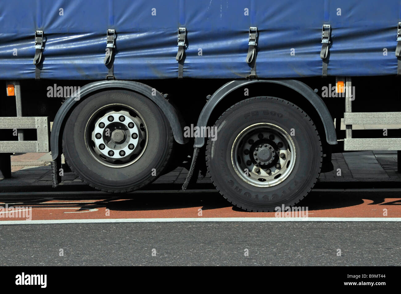 Raised lazy or dead drop droppable axle on rigid bodied lorry used to distribute heavy loads & raised to save tyre wear on soft sided curtain truck uk Stock Photo