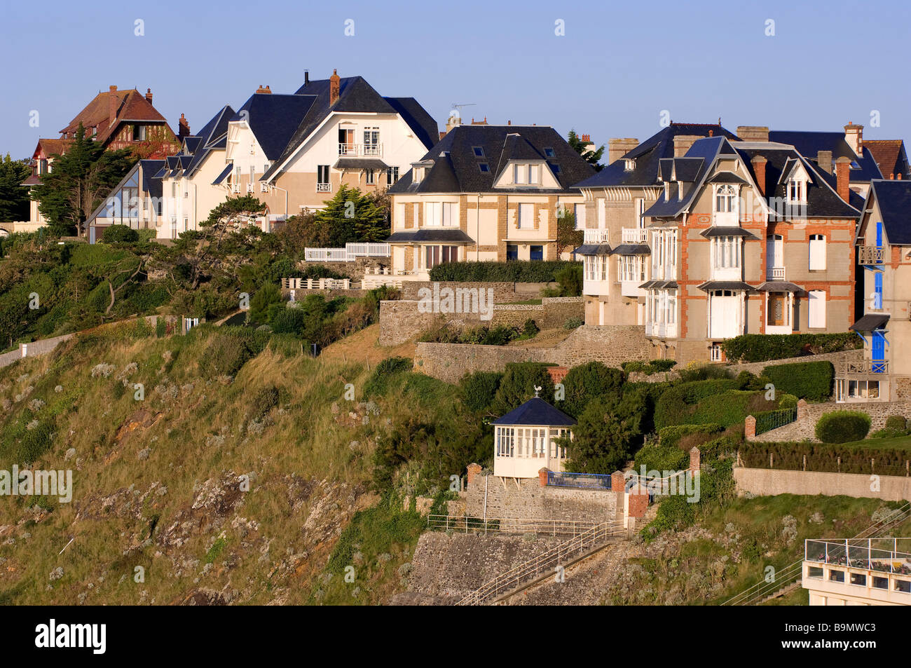 France, Manche, Granville, villas overhanging the beach and promenade