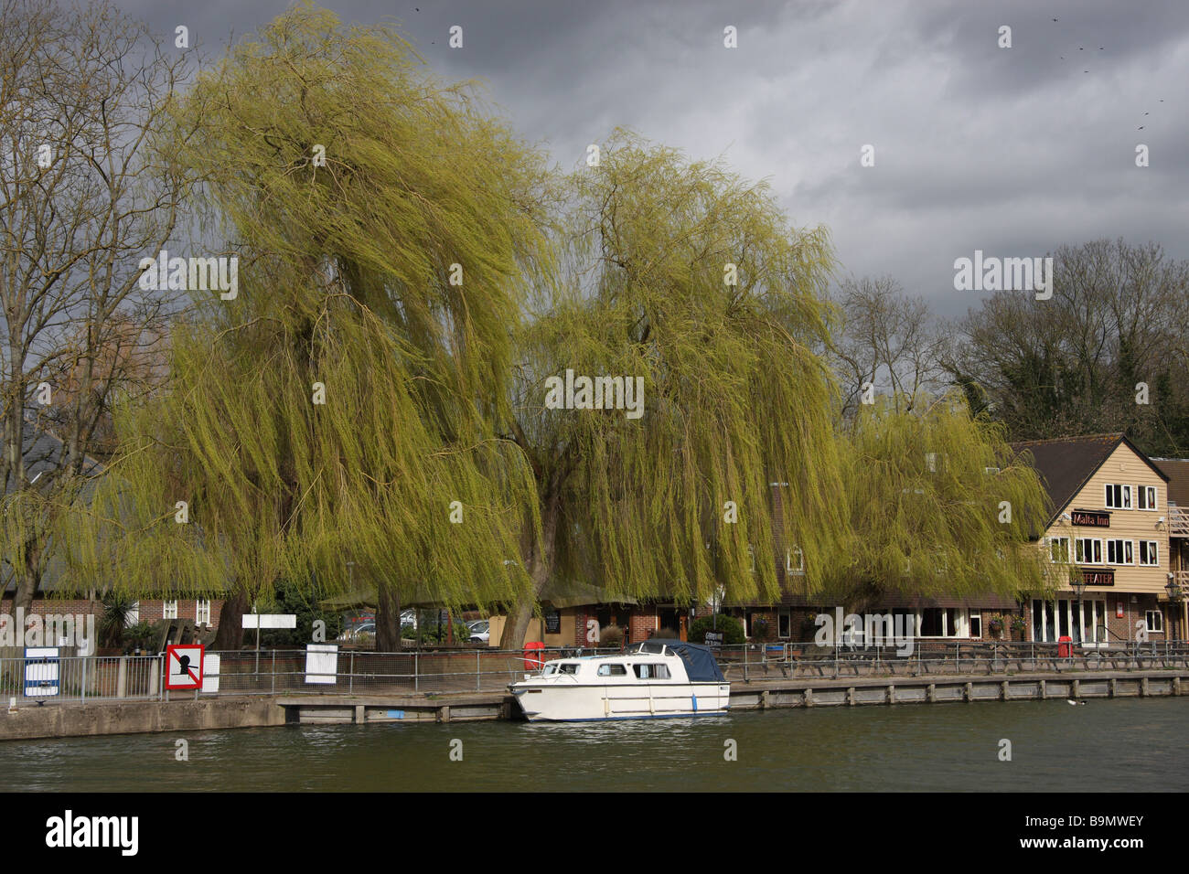 river medway shower sunshine sun clouds wind willows blowing leisure boat Stock Photo