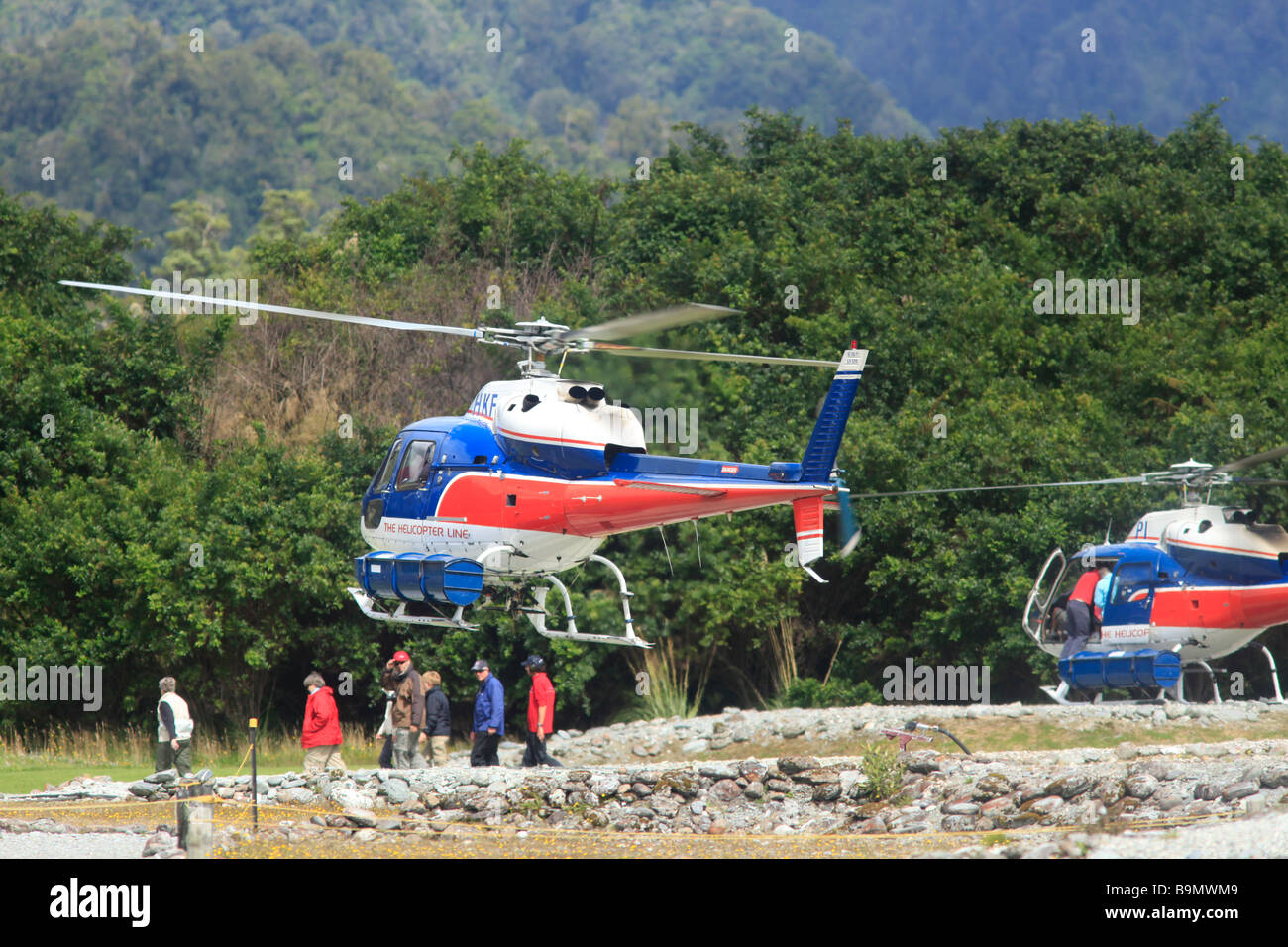 Helicopters flying tourists to the  Franz Josef glacier, Southern Alps, West Coast,South Island,New Zealand Stock Photo