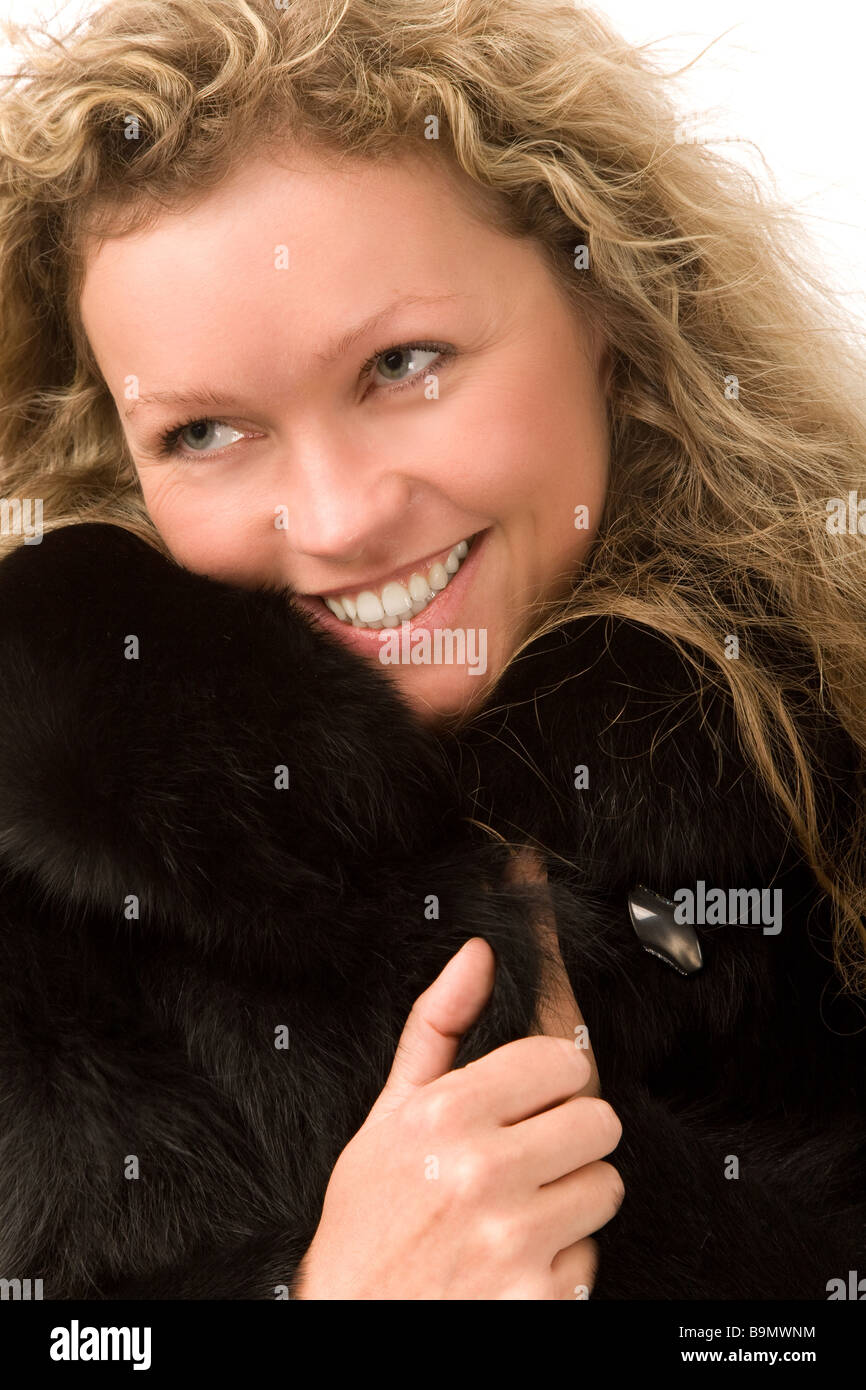 young woman in fur coat on white background Stock Photo - Alamy
