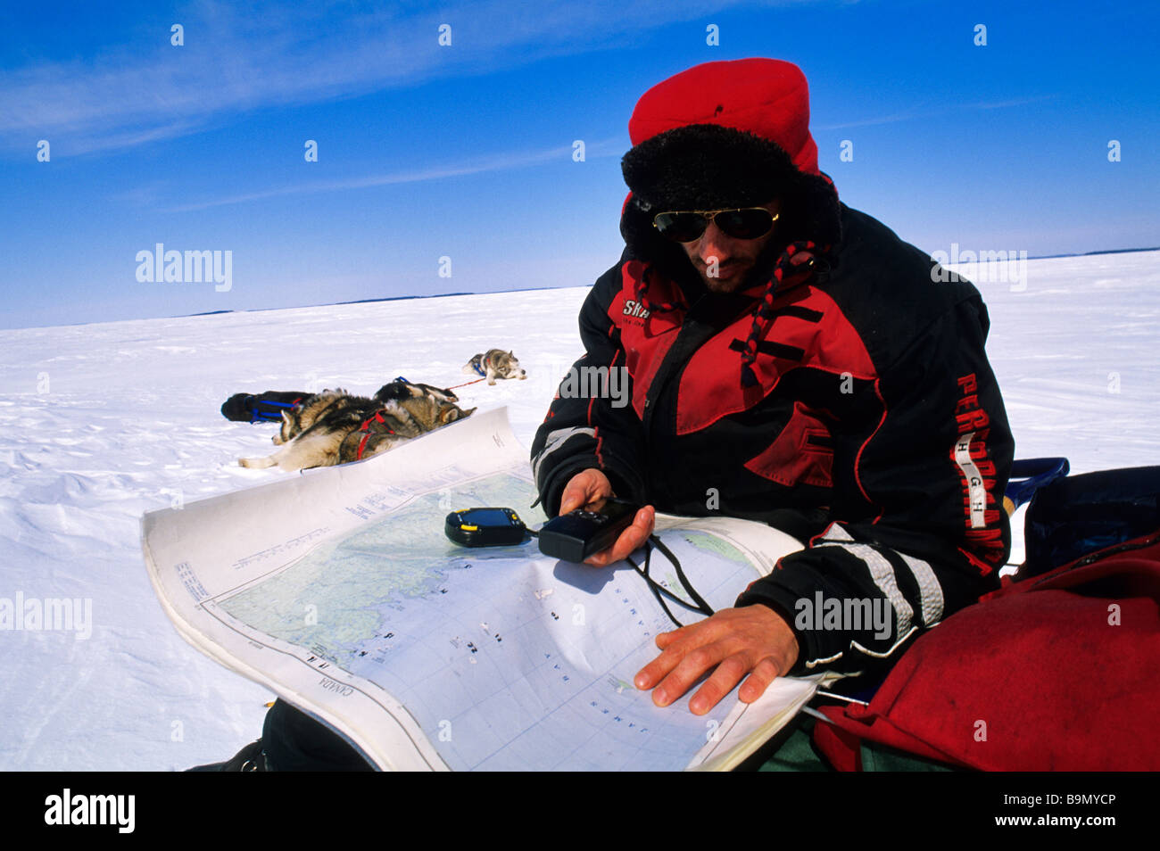Canada, Quebec Province, James Bay, near Eastman village, musher Frederic Dorgebray using a GPS to find his way on icefield Stock Photo