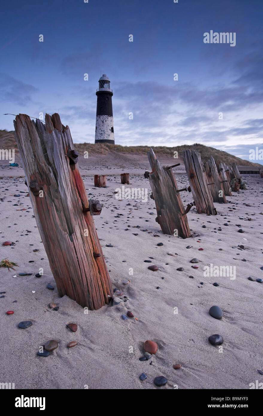 The old disused lighthouse and breawater sea defences at Spurn Point The Spurn Heritage Coastline Humberside East Yorkshire UK Stock Photo