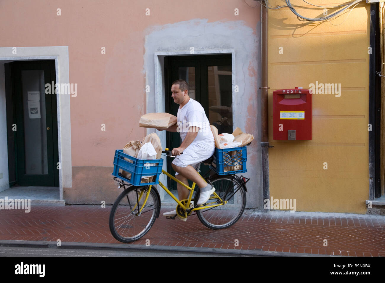 Man setting off from bakery to deliver bread early morning in Levanto Liguria Italy Stock Photo