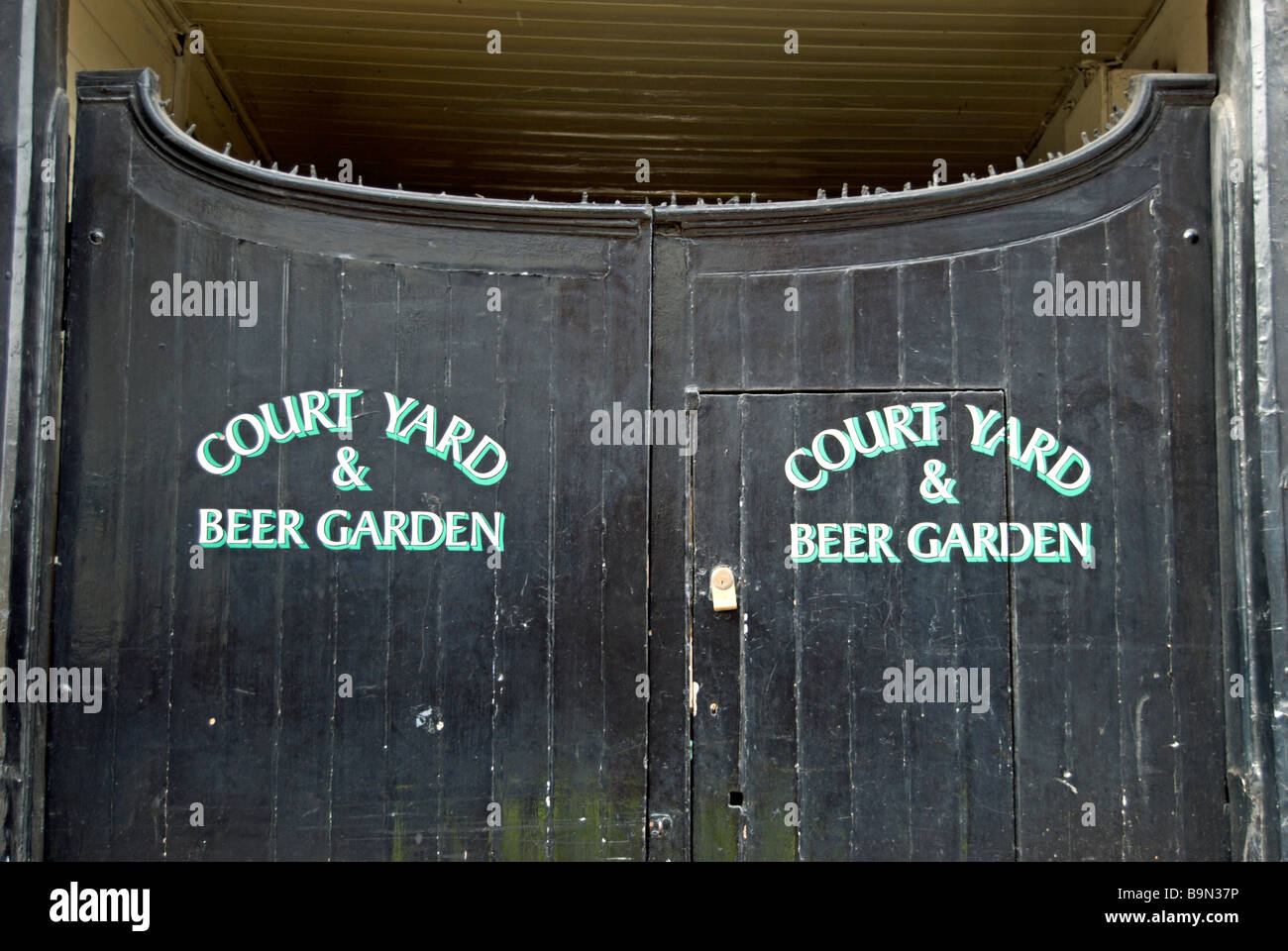 closed gates leading to the court yard and beer garden of a public house in kingston upon thames, surrey, england Stock Photo