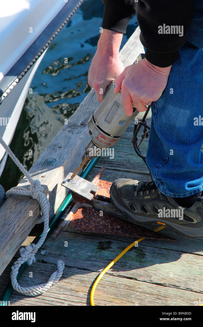 Man drilling new hole in anchor stock photo alamy